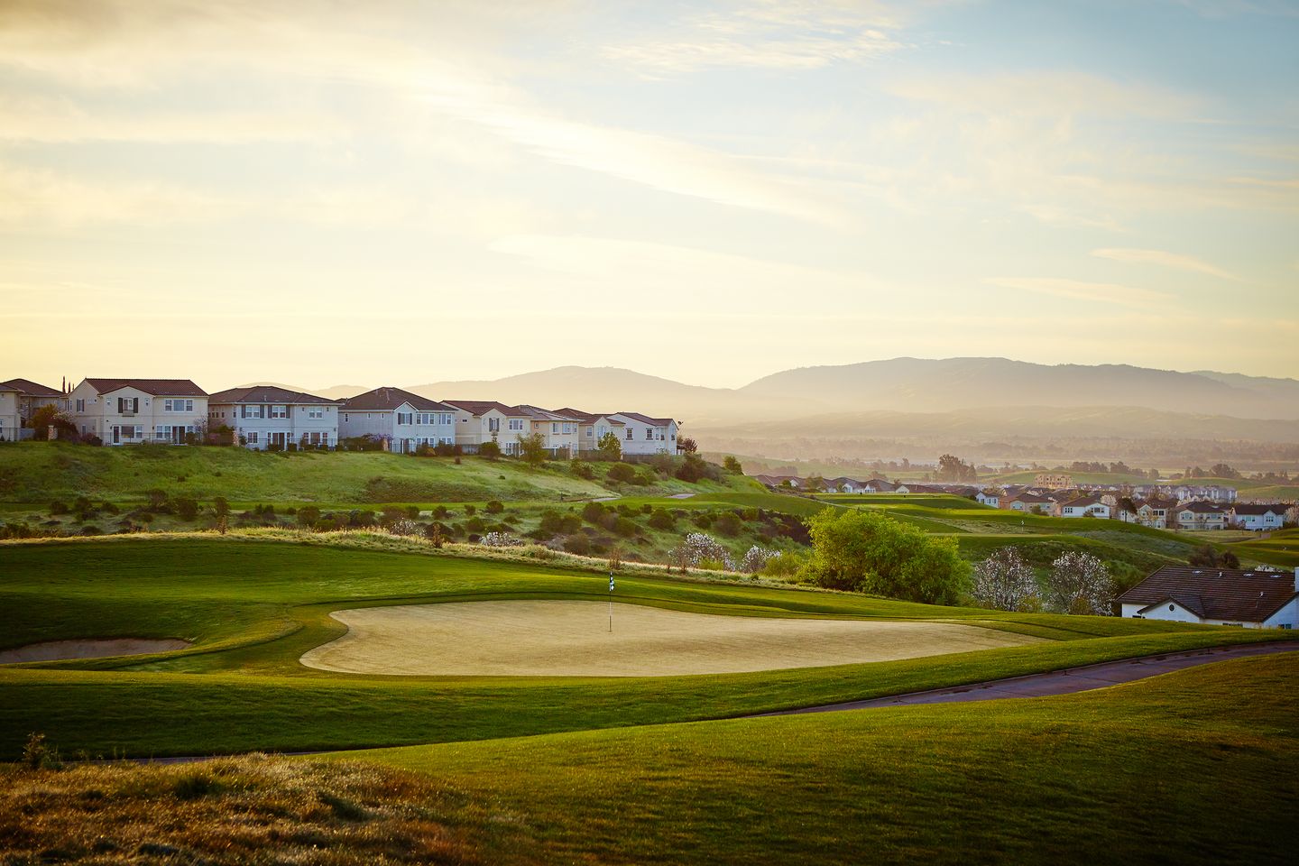 Homes above the golf course at Dublin Ranch Golf Club at golden hour